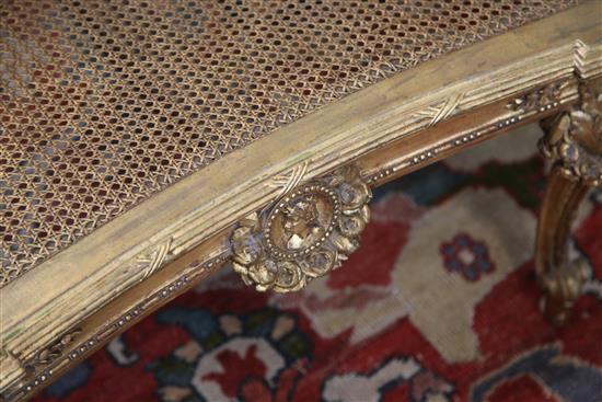 An early 20th century carved giltwood canapé, W.4ft 7in. H.3ft 1in.